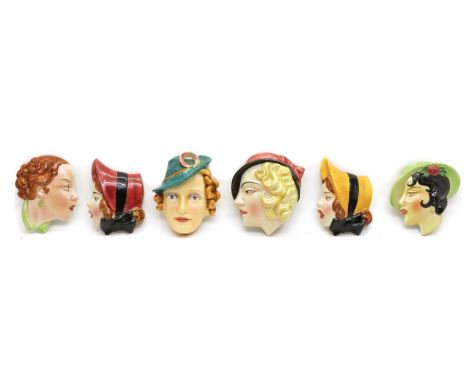 A Goebel wall mask of a lady, wearing a feather in her hat, 18.5cm high, and five further wall masks, most marked 'England or