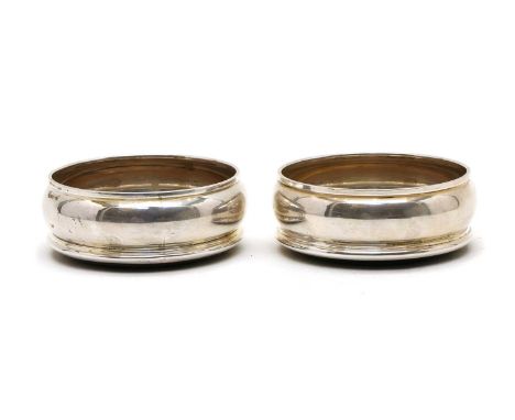 A pair of silver coasters, by Harrison Brothers &amp; Howson Ltd, London 1994, each with a turned beech base, 9.7cm diameter 