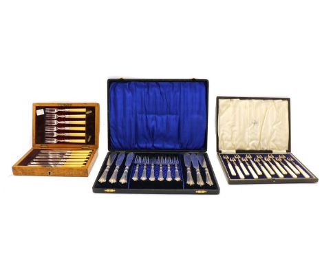 A cased set of twelve Continental silver hors d'ourves forks, with angular mother of pearl handles, together with a cased set