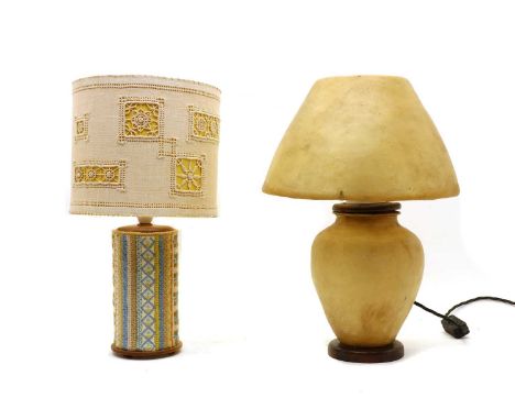 A Vellum table lamp, 1940s, of bulbous form, with a matching vellum shade, raised on a circular wooden foot, 45cm high, toget