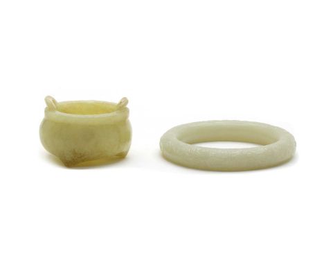 A Chinese jade bangle, carved with Eight Daoist Emblems amongst clouds, 8.1cm diameter, and a carved jade censor, of globular
