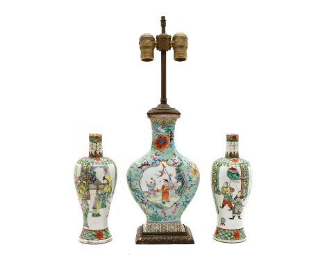 A Chinese famille rose vase, of compressed baluster form, painted with boys in the garden in pomegranate-shaped panels, surro
