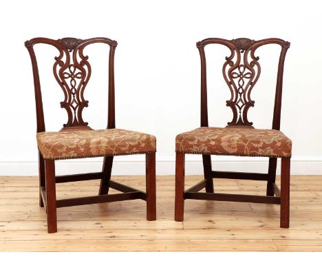 A pair of Chippendale period mahogany single chairs, with ornately carved vase shaped splats and over stuffed seats, 92cm hig