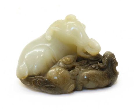 A Chinese jade carving, of a recumbent goat lying on clouds, a baby goat by its side, 7cm longCondition report: The stone wit