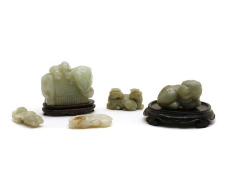 A collection of Chinese jade, comprising an elephant with a boy on its back, 8cm long, a recumbent Buddhist lion, 7cm long, a