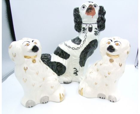 A pair of Beswick Staffordshire type dogs: together with a larger similar item (3). 