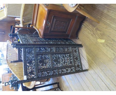 An Edwardian walnut purdonium with carved panel, an Indian three-fold fire screen and a folding cake stand
