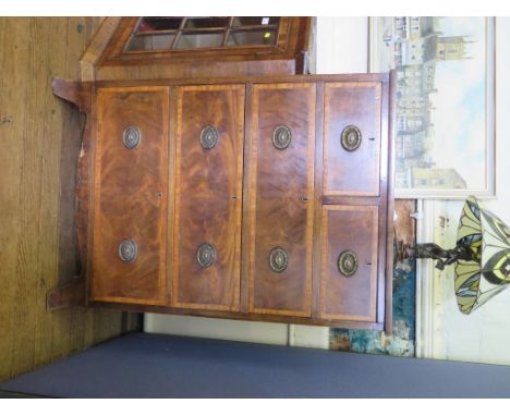 A George III style mahogany and satinwood crossbanded chest of drawers with two short and three long graduated drawers on out