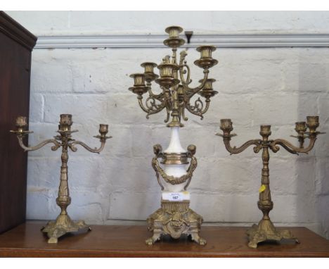 A seven light brass and white marble candelabra by Brevettato, in the French style 59cm high and a pair of five light brass c