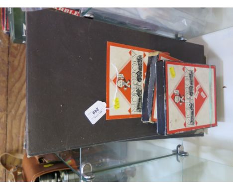 Two early Monolopy board games, one with timber and card playing pieces