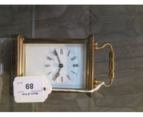 A brass carriage timepiece with enamel dial and single train movement 14cm high