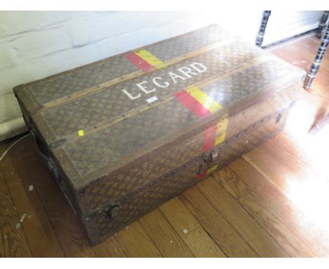 A 1930s Louis Vuitton cabin trunk, named Legard, with red and yellow bands, wooden struts and metal corners and edges, enclos