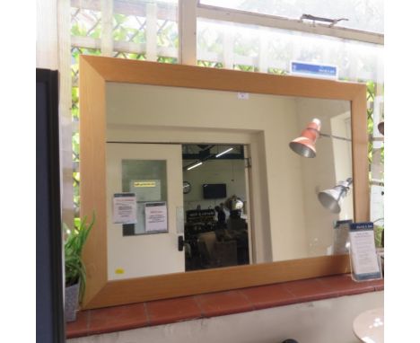 A light oak framed rectangular wall mirror, 75cm x 106cm