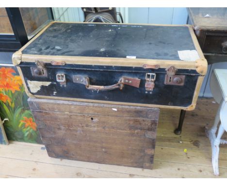 A leather suitcase, an oak metal bound trunk and a set of golf clubs
