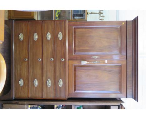 An early 19th century mahogany linen press, the cavetto moulded cornice over a pair of panelled doors, enclosing linen shelve