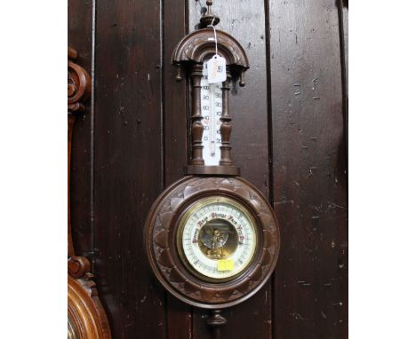 Walnut framed aneroid barometer with mercury thermometer, height 59 cm, diameter 23 cm