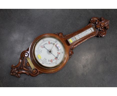 Early 20th century carved oak aneroid barometer with mercury thermometer, height 90 cm, diameter 28 cm 