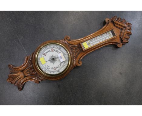 Early 20th century carved oak aneroid barometer with mercury thermometer, 64 cm x 18 cm
