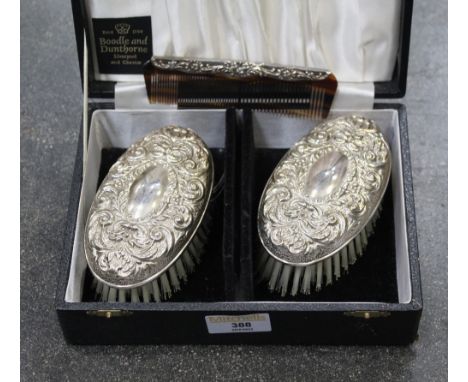 Boxed London silver hallmarked pair of brushes and comb