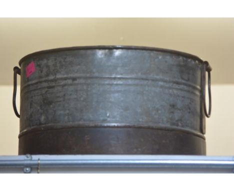 A large galvanised circular twin-handled planter. 32cm by 55cm diameter