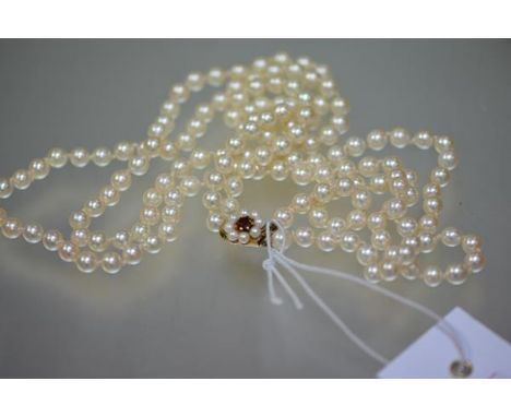 A twin-strand cultured pearl necklace, the uniform pearls on a ruby and pearl 9ct gold clasp. 59cm