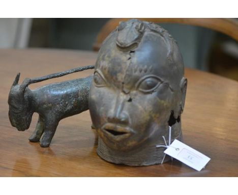 A Benin bronze head,with staring eyes and zoomorphic headdress; together with a bronze model of a wild animal, probably Benin