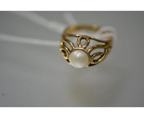 A cultured pearl ring set in 9ct gold, the pearl in a high openwork setting, mounted in yellow gold.