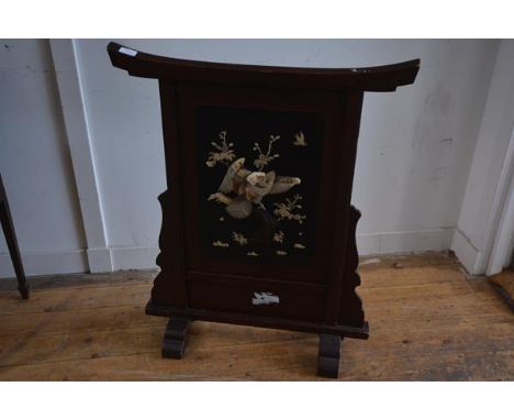 A Japanese lacquer, mother of pearl and bone mounted firescreen, Meiji period, c. 1900, in red lacquer, the central panel wit
