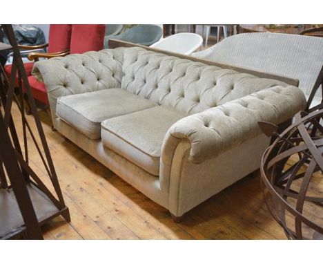 A Chesterfield sofa in 19th century style, upholstered in velvet, with two loose-cushioned seat, raised on turned legs. Lengt