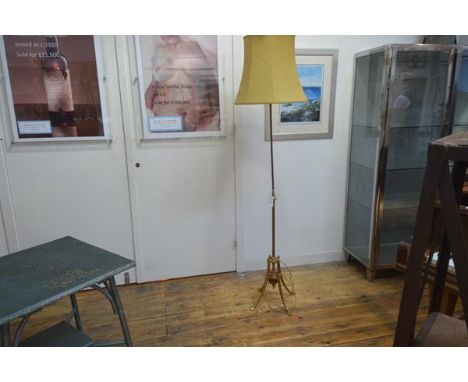 A W.A.S. Benson Edwardian copper and brass floor lamp,  the fluted standard on four splayed legs terminating in stylised leaf