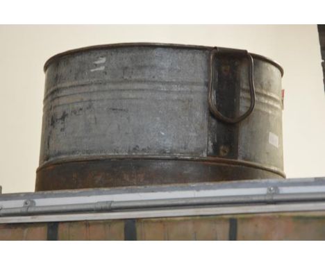 A large circular galvanised twin handled planter. 33cm by 57cm
