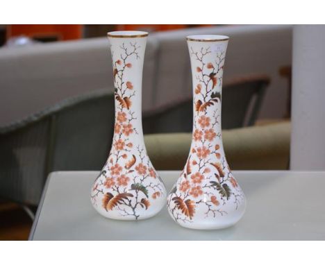 A pair of large late Victorian enamel painted opaque white glass vases, each of elongated flask form, decorated with flowerin