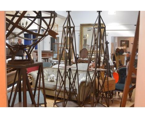 A large pair of weathered cast steel garden obelisks, each with fleur de lys finial over x-form trellis. 235cm