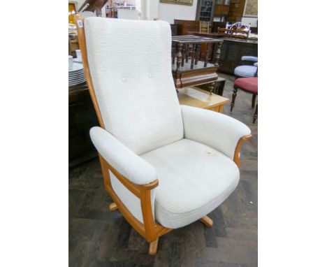 Ercol light oak framed swivel high backed easy chair in cream material