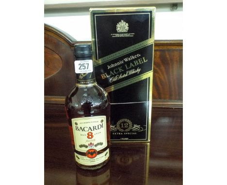 A bottle of Johnny Walker Black Label whisky and a bottle of 8 year old Bacardi rum