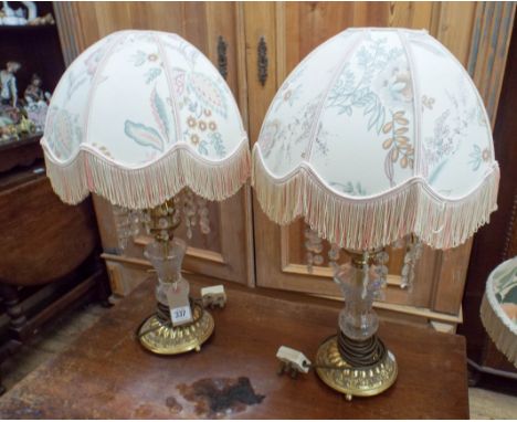 A pair of brass and glass droplet table lamps with shades and another brass vase shaped lamp 