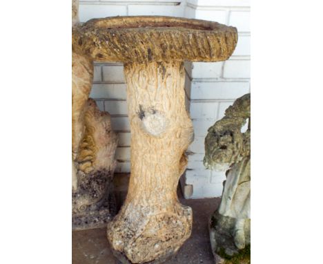 A reconstituted stone bird bath on a tree trunk style base, approximately 3' high 