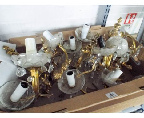 A large quantity of brass and glass with droplet wall light fittings 