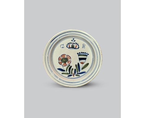 GEORGE I A London delftware 'Union' plate, c.1714, probably Vauxhall, painted in red, green and blue with crossed thistle and