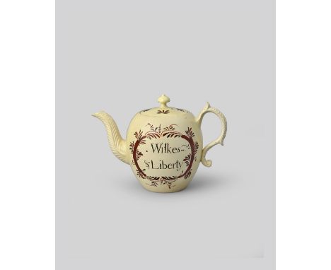 JOHN WILKES A creamware teapot and cover, c.1763-65, probably Leeds, the globular body inscribed in black with 'Wilkes &amp; 