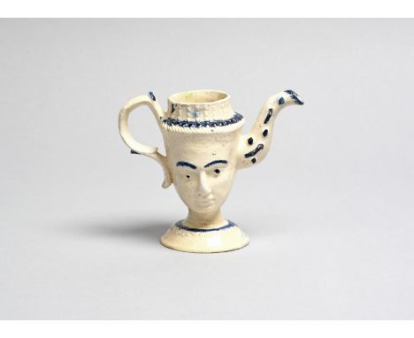 QUEEN CHARLOTTE A creamware novelty teapot, c.1790, modelled as the double maskhead of Queen Charlotte, the foreheads inscrib