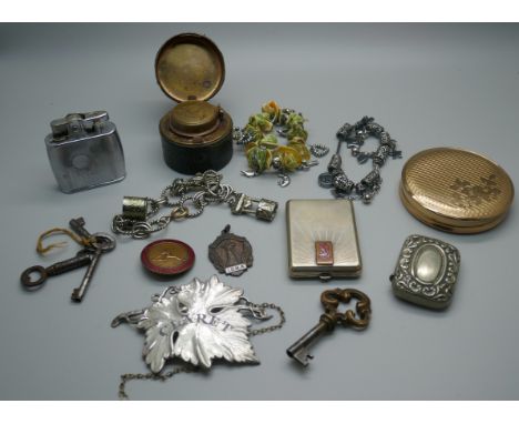 A powder case, a claret decanter label, an inkwell, a lighter, three bracelets with charms, a Women's League badge, a ballroo