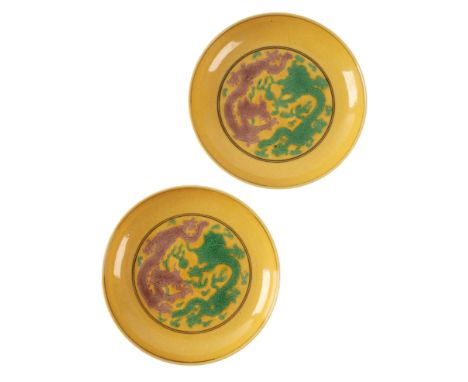 A PAIR OF CHINESE YELLOW-GROUND DRAGON PLATES decorated with five claw dragons contesting flaming pearls highlighted in emera