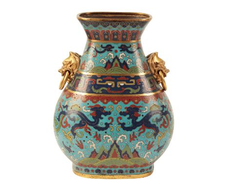 A FINE CHINESE CLOISONNE HU-SHAPED VASE with gilt lion mask and loose ring handles, decorated with guei dragons, flaming pear