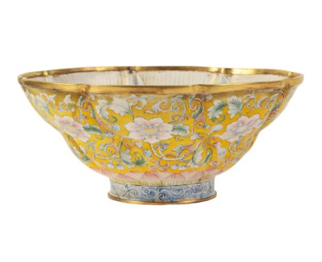 A CHINESE FAMILLE ROSE ENAMEL BOWL of moulded octofoil form, painted with flowering tendrils on a yellow ground, the interior
