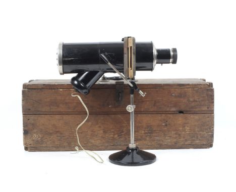 An unbranded magic lantern projector. With lens and slide holders. Contained within a wooden box with a latch, L60cm (box)