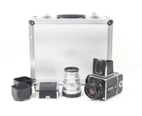 A Hasselblad 500C 6x6 medium format SLR camera outfit. Chrome. 1972. Serial No. UH 126259. With two lenses; a Carl Zeiss 80mm