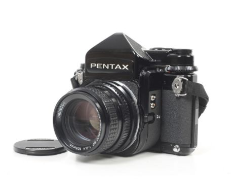 A late Pentax 67 6x7 medium format SLR camera. With an SMC Pentax 105mm f2.4 lens, all caps, prism finder, strap and instruct