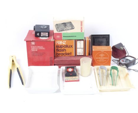 An assortment of darkroom equipment. To include three developing trays, a Paterson developing tank, and tongs. Together with 