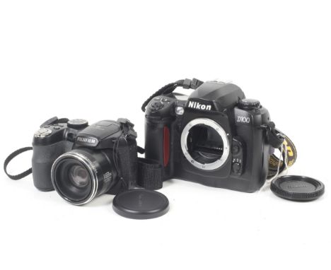 Two digital cameras. To include a Nikon D100 Digital SLR camera body, with body cap, strap and manual. Together with a Fujifi